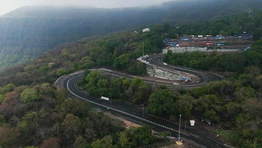 Hairpin Bend Mountain Road Through Scenic Green Hills Landscape