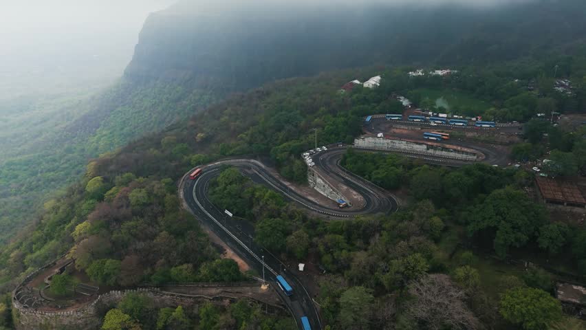 Hairpin Bend Mountain Road Through Scenic Green Hills Landscape