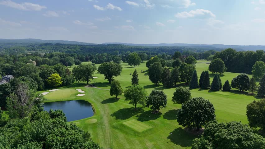 Open fields distinguished as areas for people to engage in recreational and leisure activities stretch across the well-groomed landscape below.