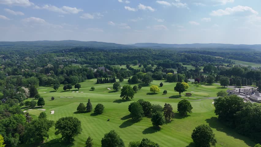 Open fields distinguished as areas for people to engage in recreational and leisure activities stretch across the well-groomed landscape below.