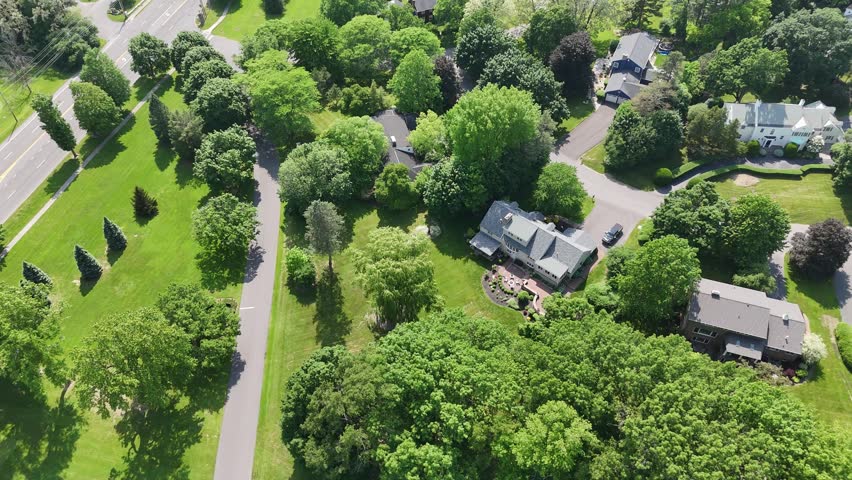 Stretches of fields interspersed with tree canopies and forests designate a rustic and scenic landscape.