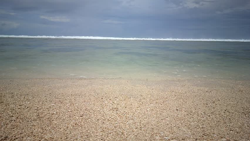 Aerial view of the Indian Ocean showing the turquoise sea surface with waves and reflected sunlight