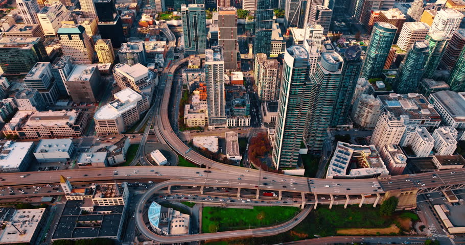 Approaching multi-lane highway with hectic traffic. Aerial perspective on the modern financial downtown of San Francisco, California, USA.