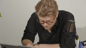 Serious male content creator working on a laptop - Powered by Shutterstock - Get 15% off with code: PIKWIZARD15