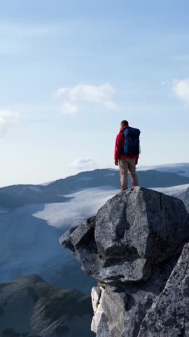Adventurer Standing on a Majestic Mountain Peak Overlooking a Breathtaking Glacier Valley, a 3D Render