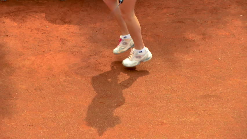 Shadow of a tennis player in a clay court