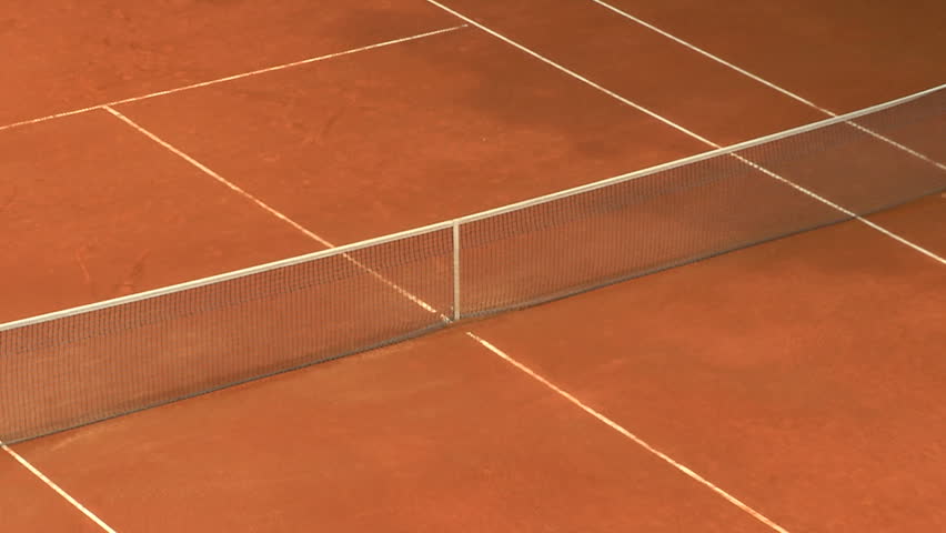 Balls bouncing on orange clay tennis court