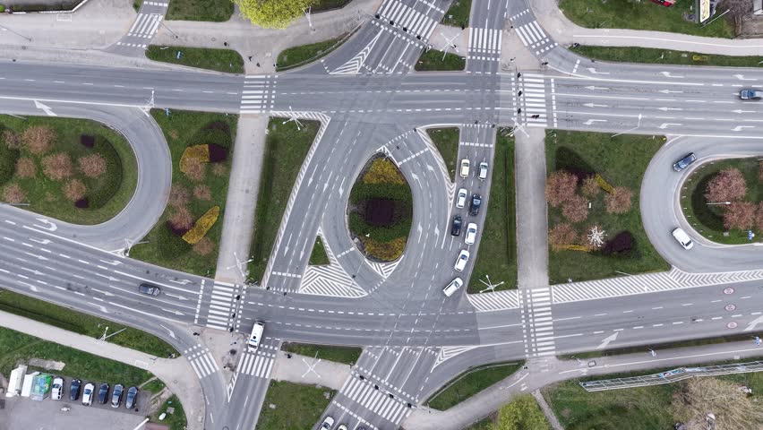 Modern city crossroads with cars and pedestrian crossings
