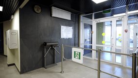 Security entrance features metallic tripod turnstile and glass doors. Dark textured stone walls create sophisticated business look - Powered by Shutterstock - Get 15% off with code: PIKWIZARD15