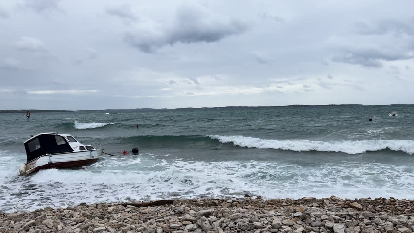 Turbulent Adriatic Sea with large waves rolling toward the coast in Novigrad. Severe storm with strong southerly winds stirred up water even in sheltered bays. Weather front season on Croatian coast.
