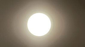 Modern round LED ceiling light with adjustable color temperatures. Close-up footage of a smart lamp switching between warm and cool white light in a dark room . - Powered by Shutterstock - Get 15% off with code: PIKWIZARD15