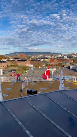 Danish flag waving on ferry deck overlooking Oslo city