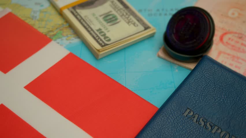 Airplane landing beside passport with visa stamp, cash, and world map with Denmark flag, concept of international travel and visa process