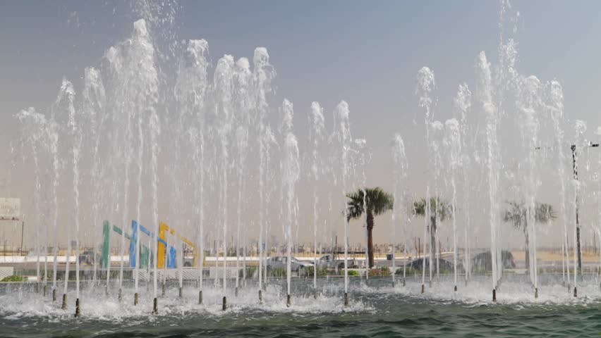 Modern Water Fountain Jets Spraying Upwards in a Sunny Outdoor Plaza in Saudi Arabia Urban Landscape