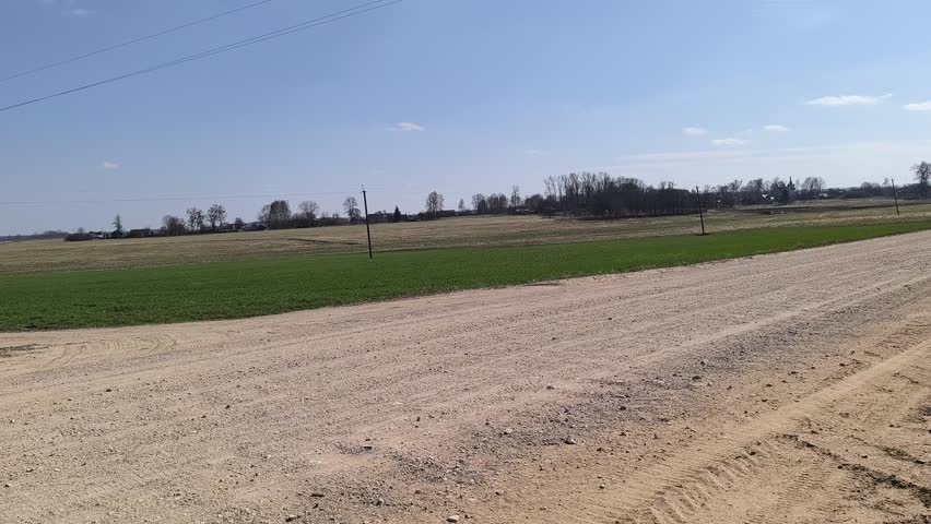 landscape with a sandy road through fields