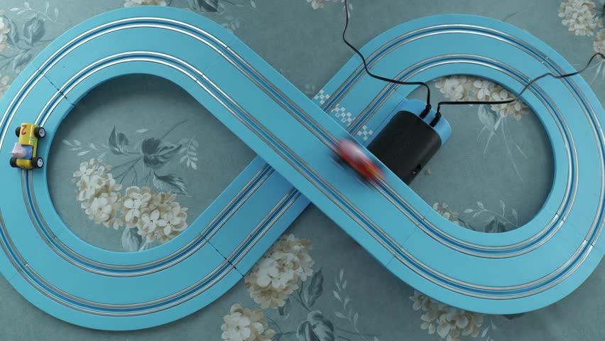 Toy slot cars race on infinity track indoors