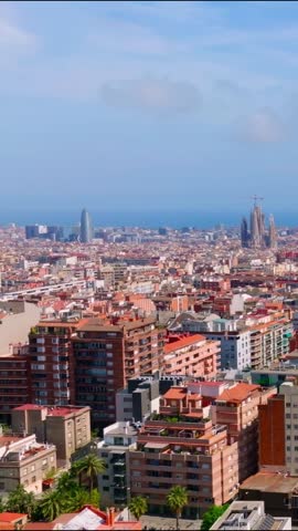 View the beauty of Barcelona from a drone. The video captures the city during summer with buildings, streets, and the sea. Explore the popular tourist spots and the vibrant atmosphere.