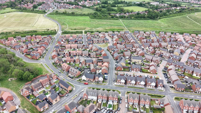 Aerial view over a new housing estate built on green belt land, United Kingdom