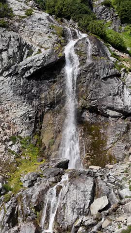 Majestic Waterfall Cascading Down Rugged Mountains in British Columbia, Canada, Revealing Alpine Beauty
