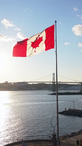Vertical Video Canada Flag Dartmouth Waterfront Halifax Skyline Behind Sunset Light Ocean View Cinematic Scene National Pride 4K