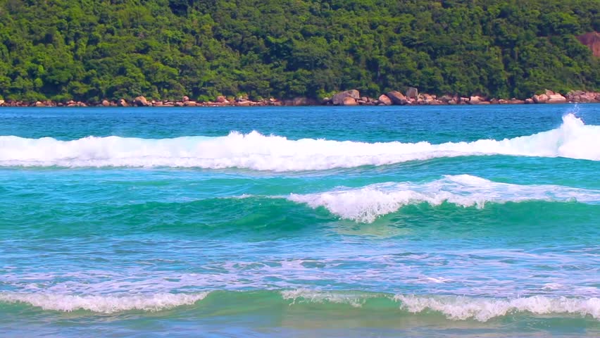 Strong waves at amazing Praia de Lopes Mendes beach on the big tropical island Ilha Grande seascape panorama ocean turquoise water blue sky in Angra dos Reis Rio de Janeiro Brazil.
