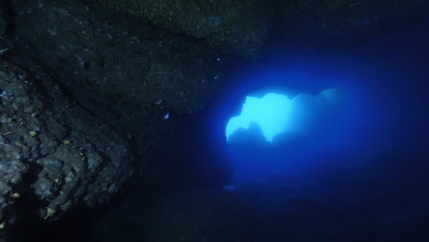 scuba divers exploring caves underwater cave diving