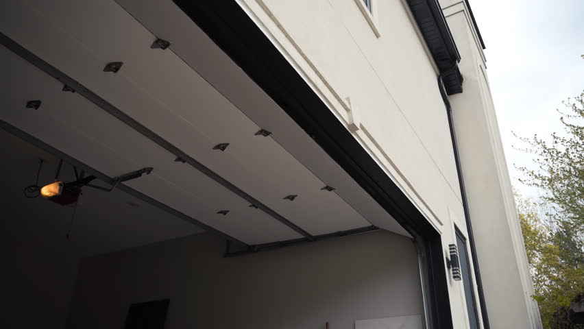 Automated garage Door closes. Residential house. Outside footage.