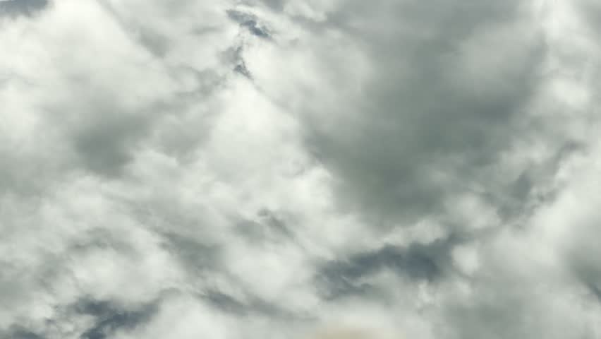 Heavy gray clouds drift across the sky, casting a soft reflection on the calm water below. This vast scene feels moody yet peaceful, capturing the quiet power of a cloudy afternoon.