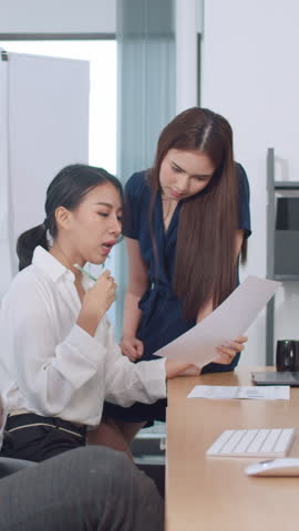 Vertical Screen : Collaborative group of multicultural business people in smart casual wear communicating and using technology while working together in office. Asia team of young professionals work.