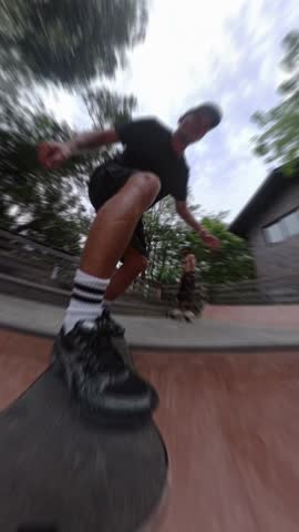 Skateboarder pov riding a half pipe ramp