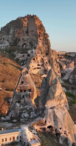 Aerial Vertical View of Ancient Cave Dwellings in Unique Rock Formations of Uchisar Castle, Cappadocia, Turkey at Golden Hour