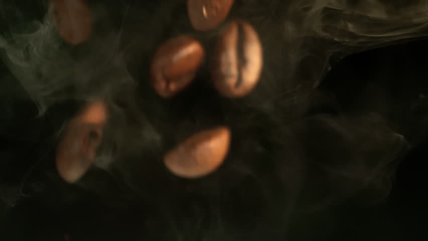 Super Slow Motion Macro of Coffee Beans Falling on Black Background at 1000fps.