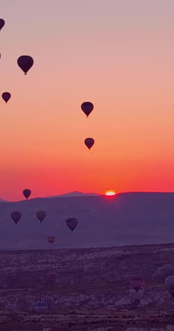 Majestic Hot Air Balloons Ascending into the Vibrant Sunrise Sky in Cappadocia, Turkey