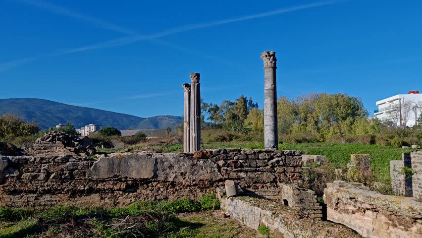 Grand View of the Ancient Roman Theater with Amphitheater Seating and Majestic Columns in Guelma, Algeria