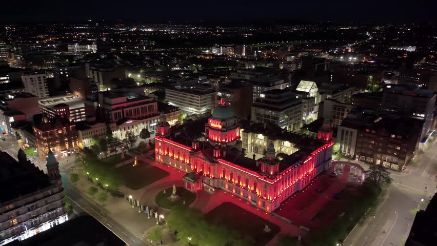 Clockwise 4K 60FPS aerial of Belfast City Hall in Belfast City Centre at night. Produced in 3840x2160 and with Rec709 color.