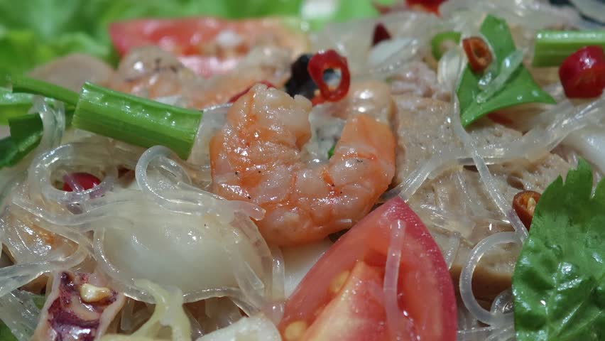 Glass noodle salad in a white plate.