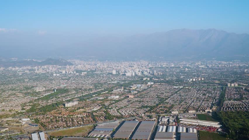 Aerial view of Santiago city urban landscape with Andes mountains from airplane window, Chile