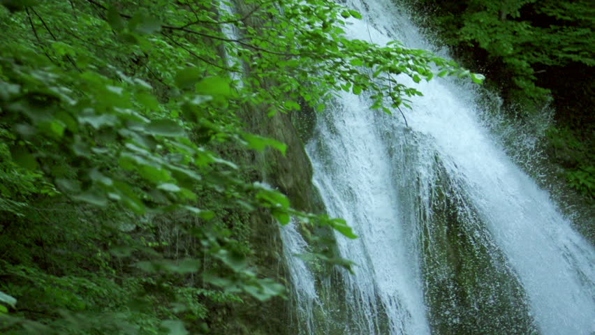waterfall in mountains in slow motion, high speed reel. super slow motion dolly