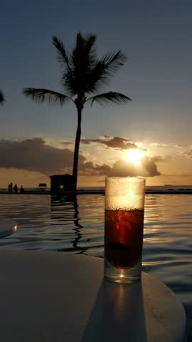 Tropical Drink in Swimming Pool at Sunset in Mauritius Island