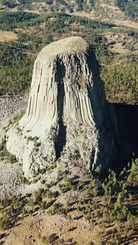 Aerial cinematic view of iconic devil tower national monument landscape in wyoming united states desert.