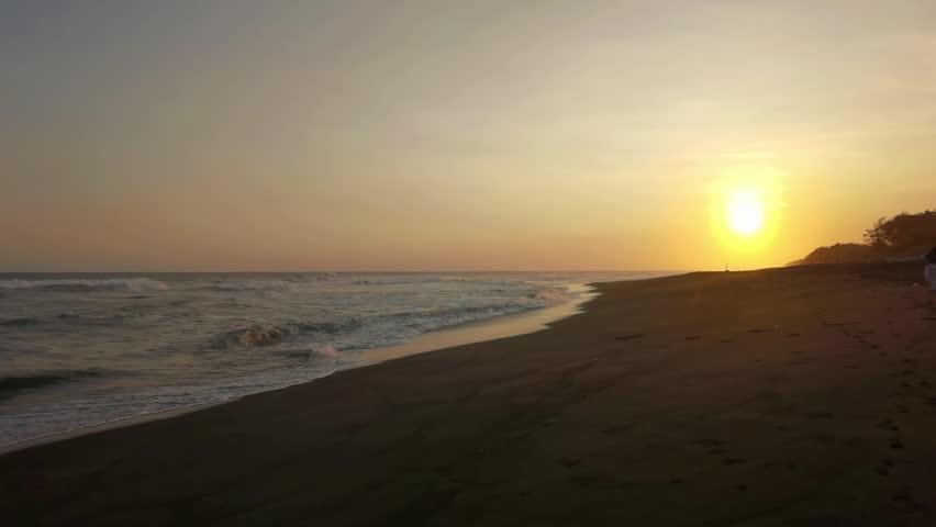 sunset on the beach with gentle waves

