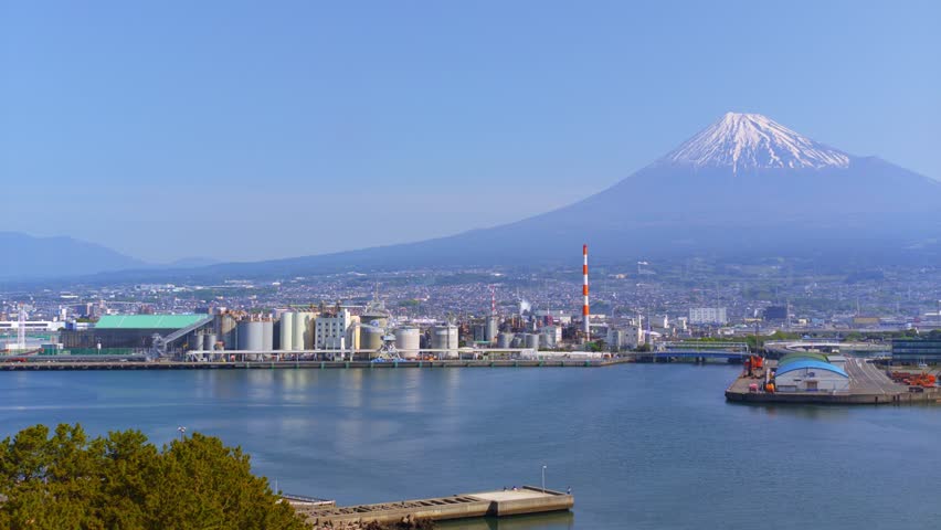 Horizontal panning shot to the right showing Mount Fuji and Tagonoura Port in Fuji City, Shizuoka, Japan.