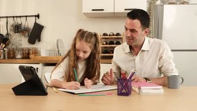 A father and daughter with her homework at a kitchen table, using colored pencils and a digital tablet for reference. - Powered by Shutterstock - Get 15% off with code: PIKWIZARD15