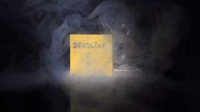 Deadline reminder with an hourglass on a dark smoky background, symbolizing urgency, time pressure, stress, productivity, planning and important time‑sensitive decisions. 4K. - Powered by Shutterstock - Get 15% off with code: PIKWIZARD15
