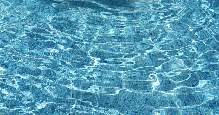 Happy family having fun in swimming pool on summer vacation. Slow motion