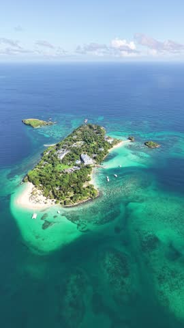 Aerial view of the stunning Cayo Levantado, also known as Bacardi Island, in Samana Bay. Cinematic drone shot featuring vibrant turquoise waters and white sand beaches in the Dominican Republic