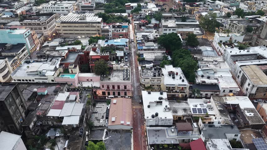 Aerial view of Columbus Park (Plaza Colon) and the First Cathedral of America in Santo Domingo. Cinematic drone shot featuring the Christopher Columbus statue and the historic colonial architecture.