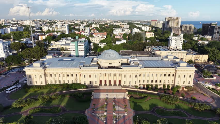 Aerial view of the National Palace (Palacio Nacional) of the Dominican Republic in Santo Domingo. Cinematic drone shot of the neoclassical government building and its gardens.