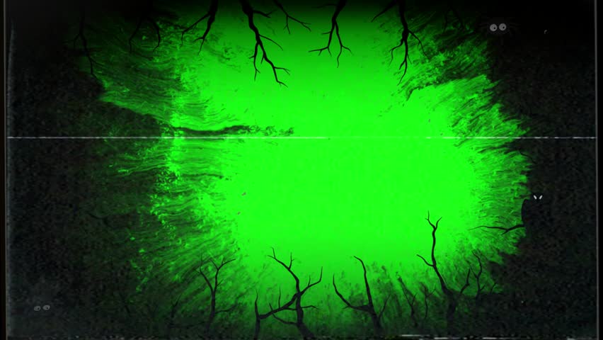 A bright green glow illuminates a dark forest scene, with silhouetted trees and branches creating a mysterious atmosphere.