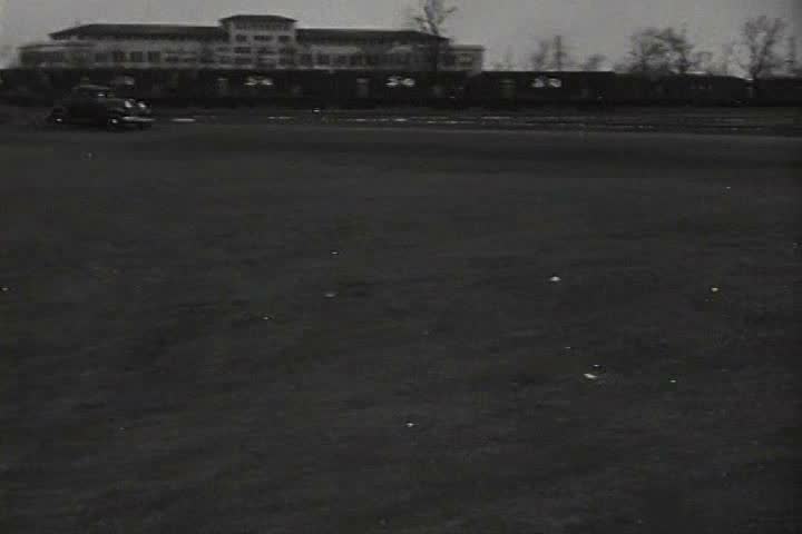 1920s - Workers arrive at a factory in 1927.